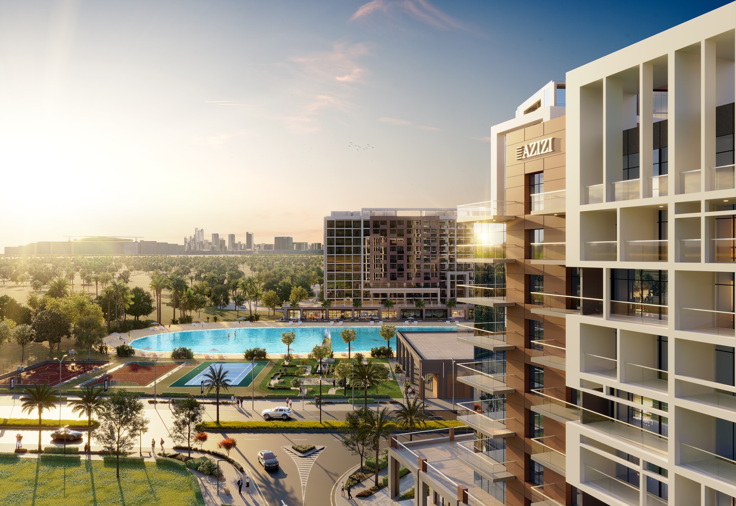 Azizi Riviera lagoon pool and tower view at golden hour with skyline in the distance
